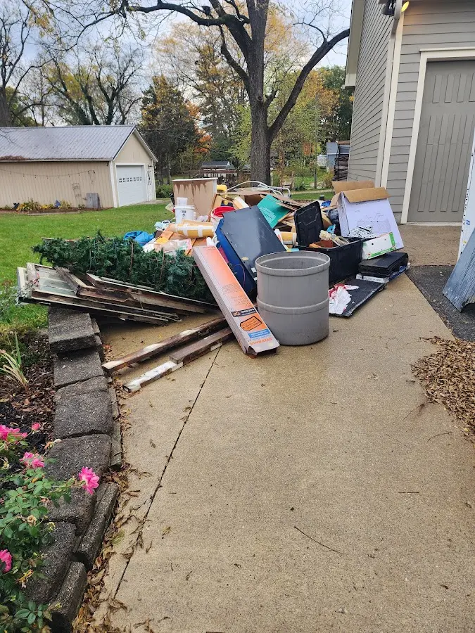 Dumpster being loaded with debris for 10 Yard Dumpster Rental in Plymouth